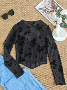 Detail of black mesh corset long sleeve top with elegant floral lace and fishbone structure.
