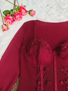 Close-up of burgundy lace bodysuit with corset boning and intricate embroidery