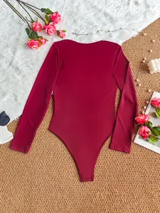 Elegant wine red long sleeve bodysuit shown in a stylish flat lay detail view