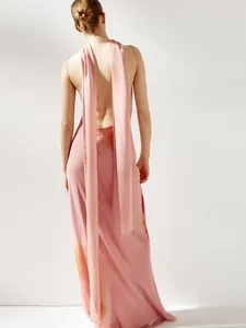 Detailed back view of a pink backless maxi dress with long decorative streamers