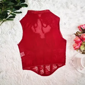 Detailed view of a red lace corset top with underwire and boned structure on white fur.