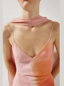 Detail of a pink gradient V-neck slip dress with spaghetti straps and matching scarf.