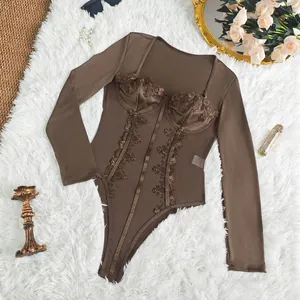 Close-up detail of the brown lace patchwork and corset boning on the long sleeve bodysuit