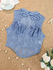 Detailed view of an elegant dusty blue lace corset top with underwire and bow tie back