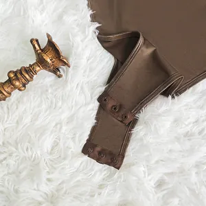 Detailed view of the triple snap button closure on a mocha brown ribbed bodysuit base