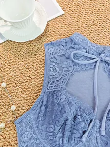 Close-up of blue lace corset top showing intricate floral patterns and back-tie detail.