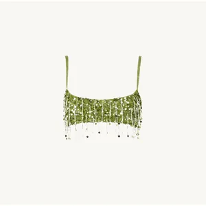Detailed shot of light green sequined camisole with delicate fringe tassels and sequins