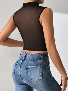 Sexy black sheer mesh sleeveless corset top with delicate lace collar and blue jeans.