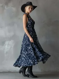 Elegant bohemian navy floral summer dress paired with a black hat and leather boots.
