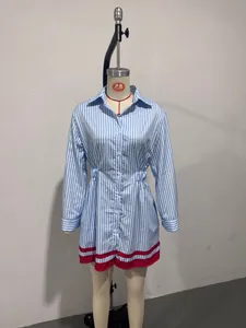 Detailed view of a striped shirt dress featuring a waist-cinching design and red hem.