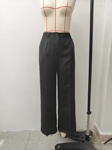 Front view showing the drape and fit of black high-waisted wide-leg tailored trousers