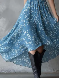 Detail shot of blue floral bohemian dress with high-low hemline for summer vacation.