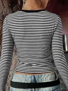 Back view of slim fit black and white striped long sleeve Y2K style t-shirt for women