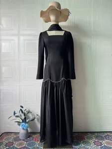 Elegant retro black long-sleeved maxi dress with square neck and rhinestone waist