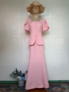 Elegant light pink two-piece set featuring beaded neckline blouse and floor-length skirt