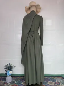 Back view detail of an elegant olive green modest maxi dress with matching headscarf