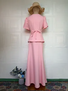 Back view of pink short-sleeve top and maxi skirt set with bow-tie waist detail