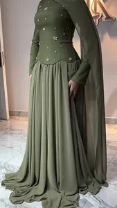 Detail view of olive green evening gown with beaded bodice and elegant cape sleeve