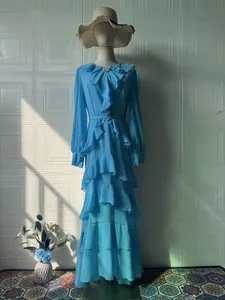 Elegant light blue long sleeve ruffle maxi dress with tiered ruffles on a mannequin