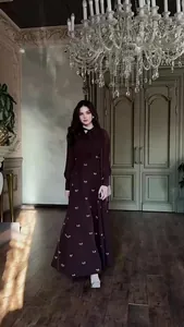 Elegant long-sleeved dress with bow prints shown in a luxurious palace-style background