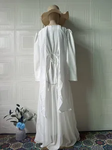 Detailed back view of an elegant white long-sleeved maxi dress with a matching shawl