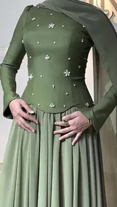 Close-up detail of dark olive green slim fit dress featuring elegant floral bead embellishments