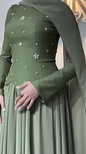 Close-up of olive green dress with rhinestone flower embellishments