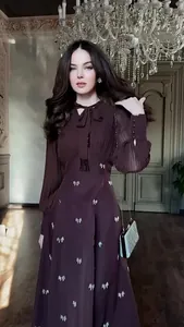 Detail of a French retro long sleeve maxi dress with elegant butterfly patterns.