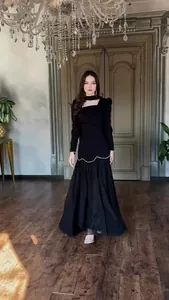 Detail view of an elegant black long-sleeve palace style maxi dress for women.