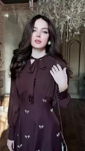 Detail view of a French retro long-sleeve dress with bow neck and sequin accents