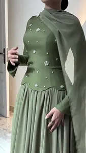 Elegant green slim dress with rhinestone floral embellishments and pleated skirt detail