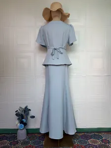 Elegant dusty blue two-piece skirt set with short sleeve peplum top and long skirt.