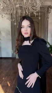 Model wearing an elegant vintage black long-sleeved dress with choker and puff sleeves