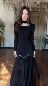 Elegant black long-sleeved maxi dress featuring vintage palace style with wavy pearl trim