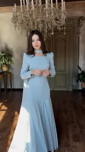 Elegant light blue long-sleeved court style maxi dress shown in a luxury interior setting