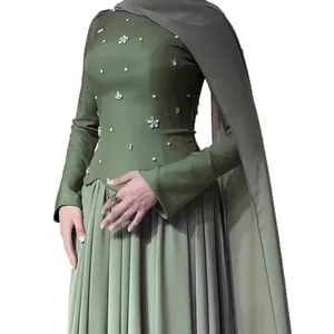 Elegant olive green slim long-sleeve dress with silver floral beadwork and cape.
