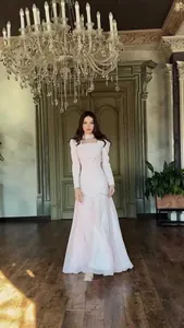 Elegant long-sleeved maxi dress shown in a grand vintage palace setting, full detail