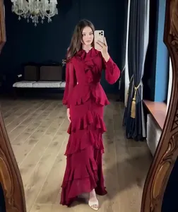 Elegant long-sleeved tiered ruffle maxi dress in burgundy displayed in a mirror selfie