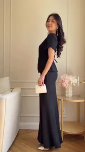 Elegant black two-piece skirt set featuring a short-sleeve top and a floor-length skirt