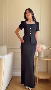 Elegant black two-piece set featuring a square neck peplum top and long skirt