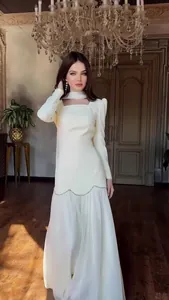 Full view of an elegant white long sleeve vintage dress with beaded pearl details