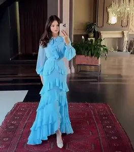 Full view of light blue elegant long-sleeve tiered maxi dress for women in luxury setting