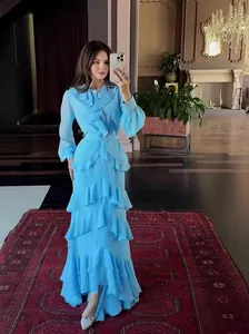 Elegant light blue tiered ruffled maxi dress with long sleeves for a high-end summer look.