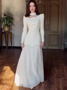 Elegant white long-sleeved court style maxi dress with puff sleeves and vintage collar.