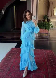 Elegant light blue long-sleeve maxi dress with tiered ruffles and belted waist