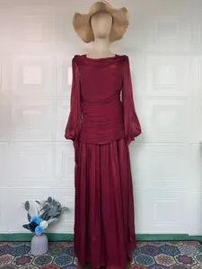 Detail of elegant wine red long-sleeved maxi dress with pleated waist design