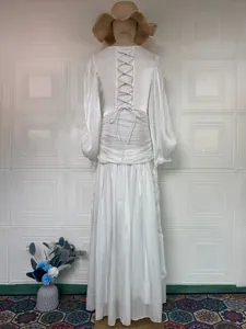 Back view detail of elegant white French long-sleeved dress with lace-up waist design