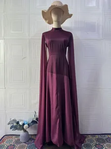 Elegant plum long-sleeved maxi dress featuring dramatic cape sleeves and a stylish high neck