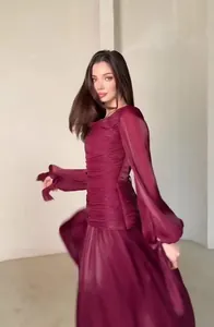 Detailed view of elegant burgundy long-sleeved pleated maxi dress with French style