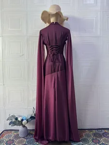 Detailed back view of plum long-sleeved dress with corset lace-up and cape sleeves